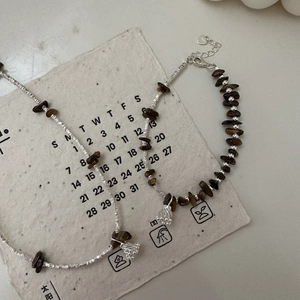 S925 sterling silver bracelet and necklace set with tiger eye stones on vintage paper