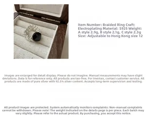 Macro detail of S925 sterling silver woven ring with an oval black gemstone inlay