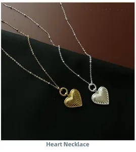Close-up of gold and silver heart necklaces with vintage radial textures on leather