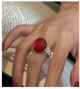Detail of red gemstone ring with silver bead band and elegant vintage aesthetic