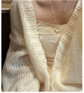 Close-up of S925 sterling silver heart pendant necklace with fine textured sunburst detail