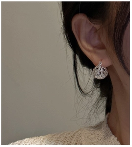 Nahaufnahme von S925 Sterling Silber Hohlkugel Ohrring an einem Modell für modernen Look