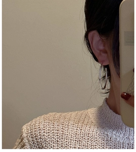 Close-up of S925 sterling silver large hoop earrings with irregular wavy matte finish