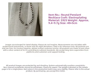 Detail of S925 sterling silver beaded necklace with embossed portrait coin pendant
