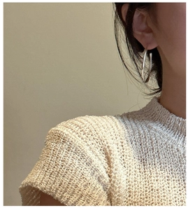 Close-up of minimalist S925 sterling silver hoop earrings worn by a model