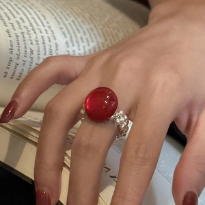 S925 silver beaded ring with red acrylic cabochon stone on elastic band worn on finger
