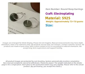 Macro view of S925 sterling silver hoop earrings featuring dark green gemstone charms