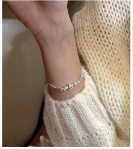 Close-up of S925 sterling silver triple-layered bead bracelet on a model's wrist