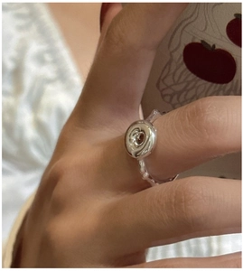 Detail showing the textured donut swirl design and handmade metal finish on S925 silver ring