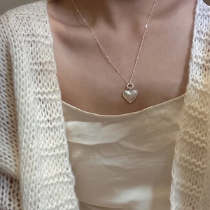 Elegant S925 sterling silver heart pendant necklace on a knit sweater model background