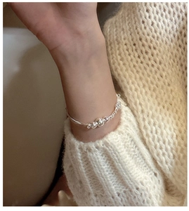 Close-up of minimalist S925 sterling silver triple-layer beaded bracelet on female wrist