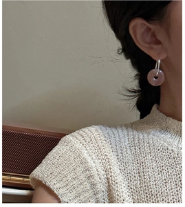 Detail of pink chalcedony donut drop earrings in S925 silver worn by a model