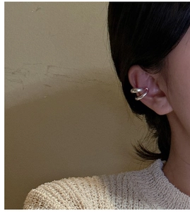 Détail d'une boucle d'oreille ear cuff mate en argent S925 portée sur le cartilage