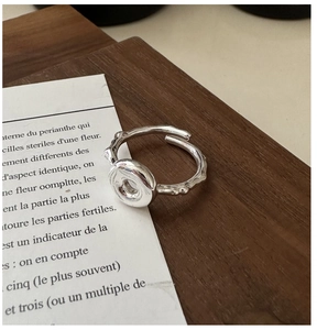 Detail of S925 sterling silver ring with irregular lava texture and donut design