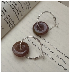 Detailed shot of S925 silver hoop earrings with marbled stone safety buckle pendants