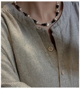 Detailed view of S925 silver necklace with black agate beads and cat-eye stones