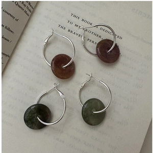 Detail view of S925 silver hoop earrings with red and green agate safety buckles
