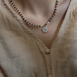 S925 sterling silver tiger eye beaded necklace with retro coin pendant on model