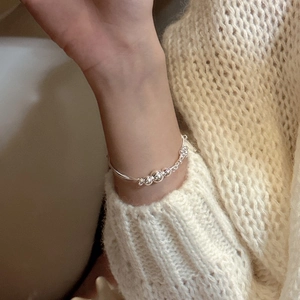 Minimalist S925 sterling silver triple-layer beaded bracelet on a beige knit sweater