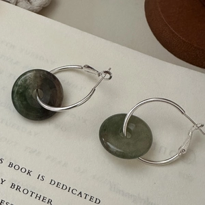 Minimalist S925 sterling silver hoop earrings with vintage green jade pendant on a book