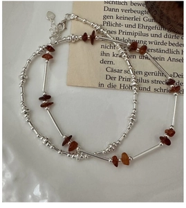 Detailed close-up of S925 sterling silver chain with reddish-brown crystal beads