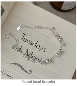 Detail of S925 sterling silver beaded bracelet with lobster clasp on a book background