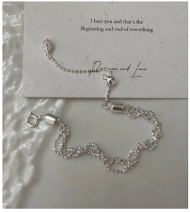 Detail of adjustable S925 sterling silver multilayer beaded bracelet with slider clasp