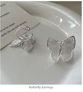 Detailed close-up of S925 silver butterfly ear clips with elegant hollow mesh design