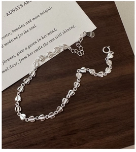 Close-up of S925 sterling silver heart-shaped bracelet showing brushed metal texture