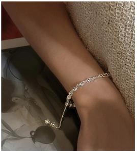 Detail of adjustable S925 sterling silver winding bracelet worn on wrist with drawcord