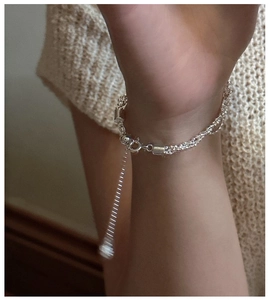 Detail view of double-layer S925 silver bracelet with adjustable slider on a wrist