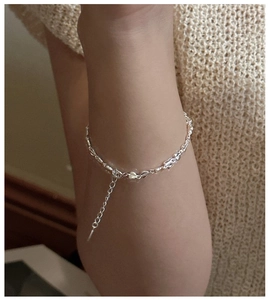 Close-up of S925 sterling silver heart and olive link bracelet with extender chain