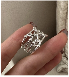 Close-up of S925 sterling silver multi-layer crisscross ring with small beaded accents
