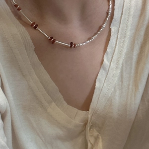 Minimalist S925 sterling silver beaded necklace with red gemstones on female model