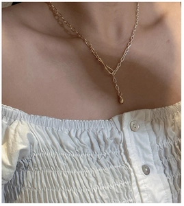 Detail of S925 silver two-tone link necklace with unique hook clasp and ball pendant