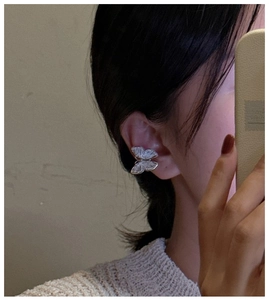 Close-up of S925 sterling silver butterfly ear cuff with striped engraving details