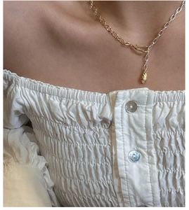 Detail of S925 sterling silver two-tone necklace on neck showing organic pendant