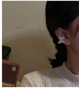 Detail of S925 silver butterfly ear cuff shown worn on ear for minimalist styling