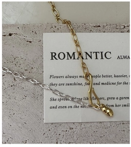 Detail of S925 silver mixed metal chain with gold S-hook and teardrop pendant