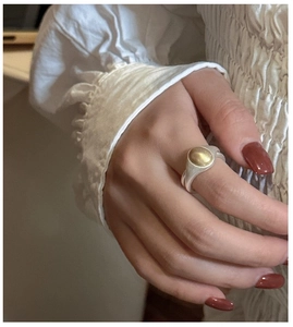 Close-up of S925 sterling silver two-tone wide ring with matte brushed finish