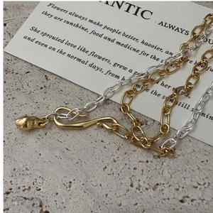 Detail of S925 sterling silver S-hook clasp with engraved stamp and two-tone O-chains