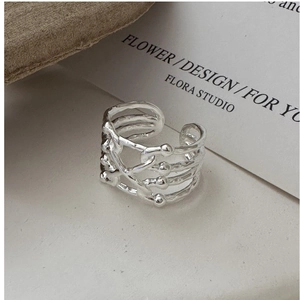 Detail of S925 sterling silver multilayer cross ring with hammered texture and micro beads