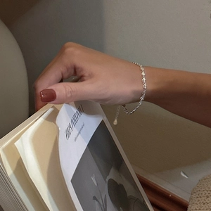 Elegant S925 sterling silver heart bracelet worn by model in a minimalist setting