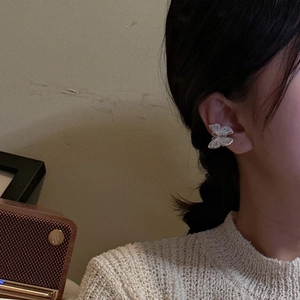 Minimalist S925 sterling silver butterfly ear cuff shown worn on a model's ear