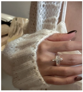 Detail of S925 sterling silver safety pin ring with multiple bands on model's finger