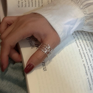 Minimalist S925 sterling silver multi-layer crossover ring with polished finish worn on thumb