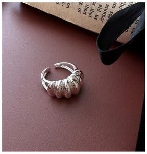 Macro shot of S925 sterling silver ring showing croissant texture and silver hallmark