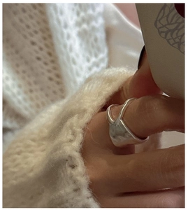 Detail of S925 sterling silver double-layer ring with matte hammered texture on model hand