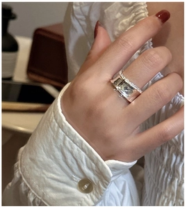 Macro detail of S925 sterling silver wide ring with twisted rope texture and wavy edge