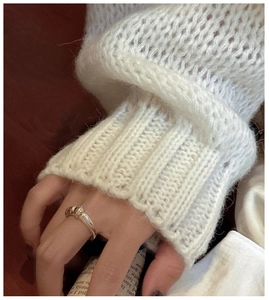 Detail of S925 sterling silver ring with two-tone beads worn on a finger